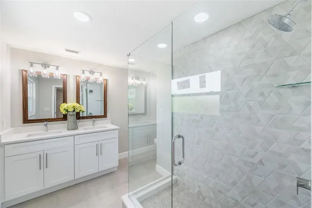 an empty room with wooden floor closet and windows