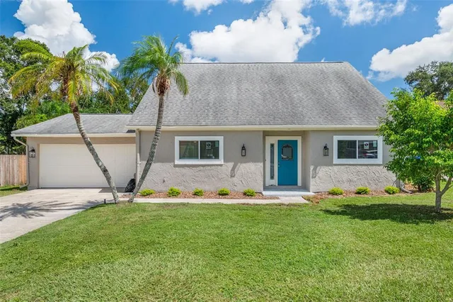 a front view of house with yard and green space