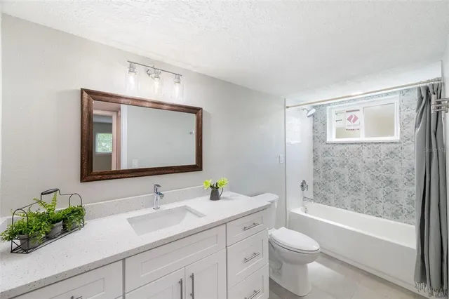 a bathroom with a bathtub shower sink and toilet