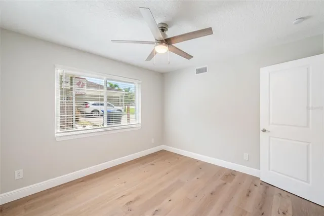 a front view of a house with a garden and plants