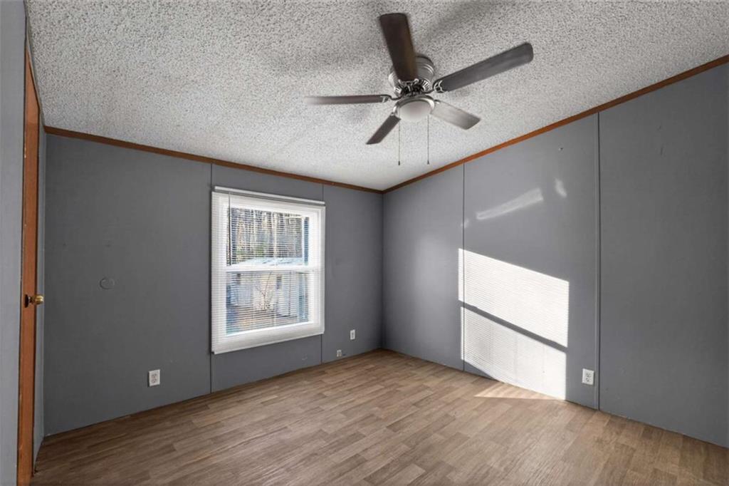 205 Wilson Road Stockbridge, GA 30281 - Photo 12 of 18 a view of an empty room with a window and wooden floor
