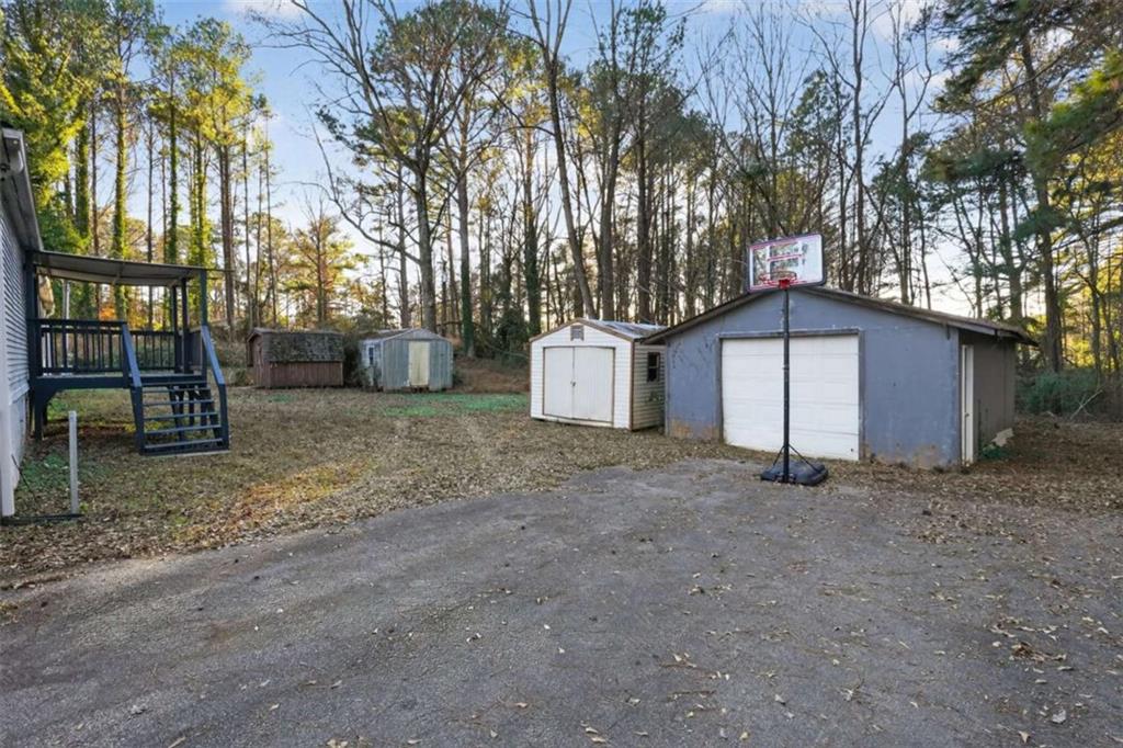 205 Wilson Road Stockbridge, GA 30281 - Photo 14 of 18 a view of a house with a yard and tree s