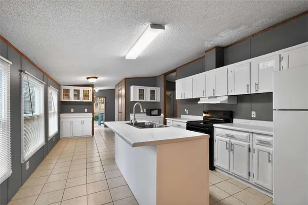 a kitchen with stainless steel appliances a stove refrigerator sink and cabinets