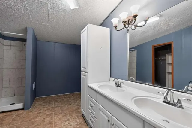 a bathroom with a double vanity sink and a mirror