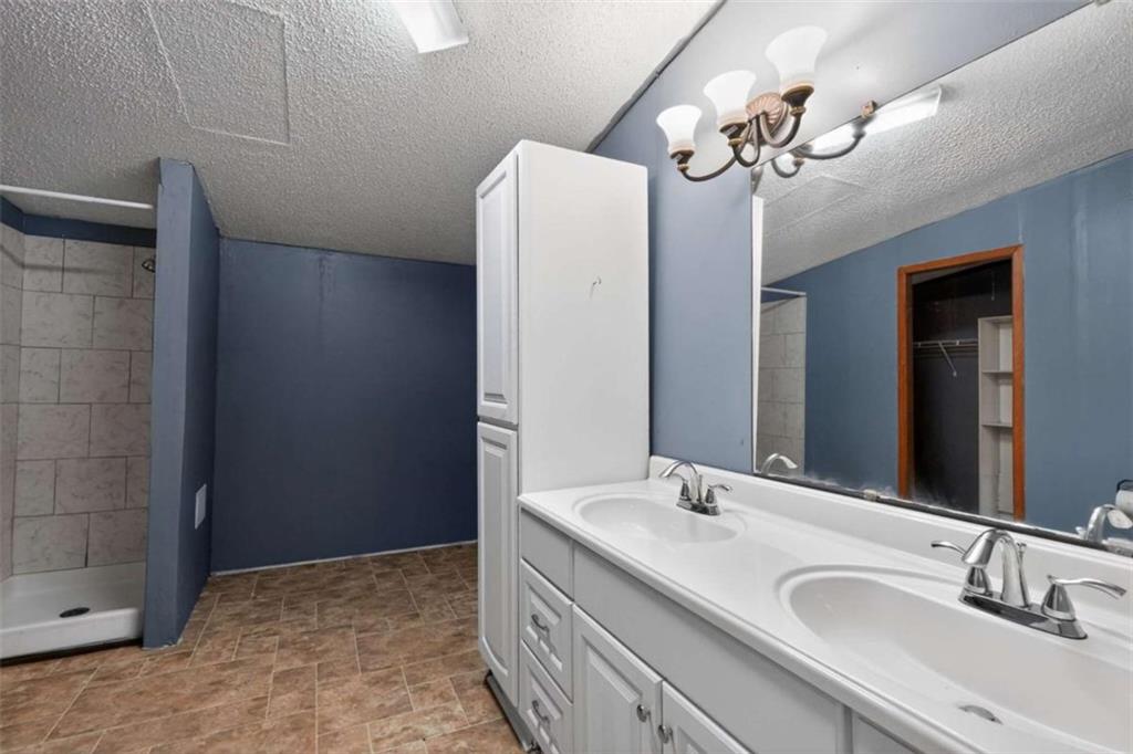 205 Wilson Road Stockbridge, GA 30281 - Photo 10 of 18 a bathroom with a double vanity sink and a mirror