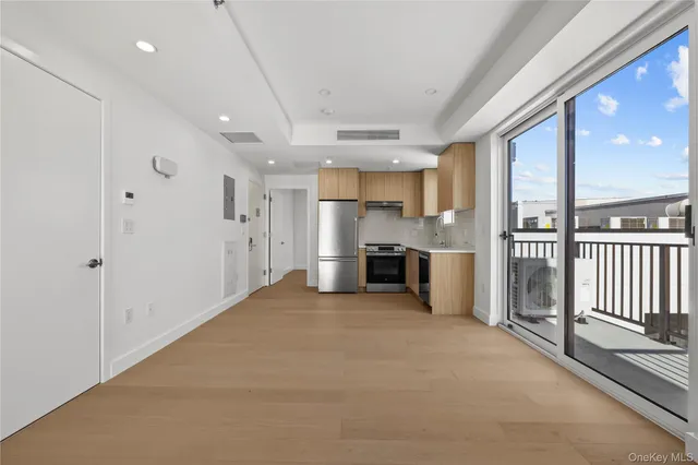 a living room with fireplace furniture and a large window
