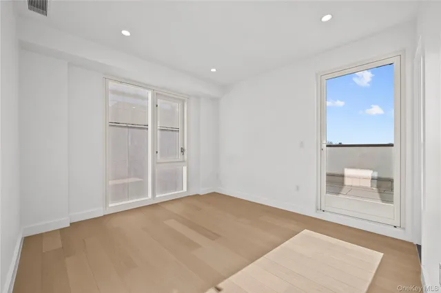 a bedroom with a bed and a potted plant