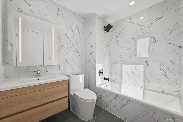 a bathroom with a sink toilet a mirror and shower