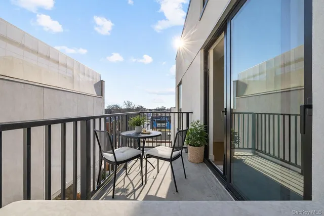 a balcony with chairs and wooden floor