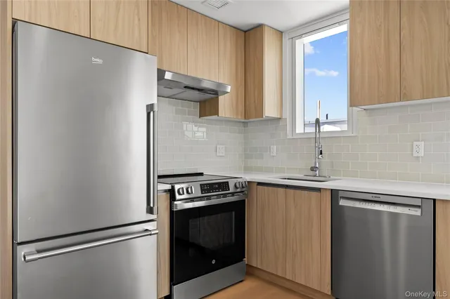 a kitchen with a stove and a refrigerator