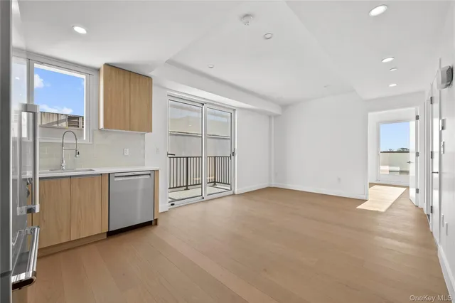 a view of a kitchen with wooden cabinet and a stove top oven