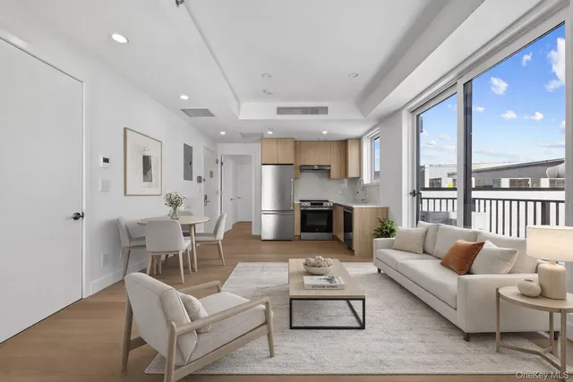 a view of a kitchen with a sink and refrigerator