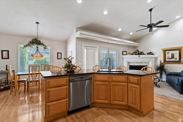 1924 North 2000th Street East Layton, UT 84040 - Photo 40 of 41 Kitchen with open floor plan, light wood finished floors, a ceiling fan, wood finish cabinets, and vaulted ceiling