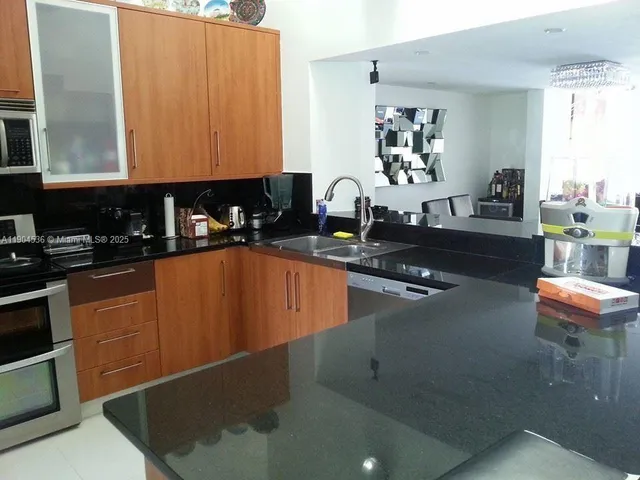 a kitchen with sink cabinets and outdoor view