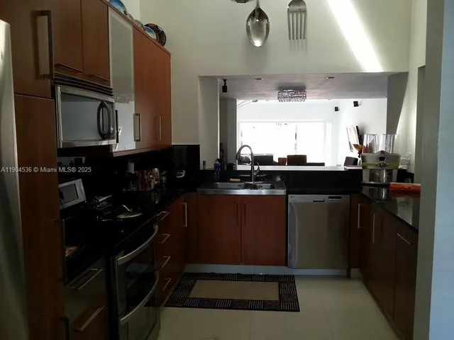 a kitchen with a sink appliances and cabinets