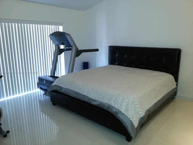 a bedroom with a bed and a night stand