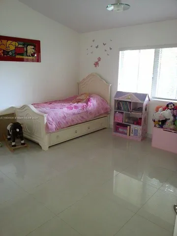 a bedroom with bed and window