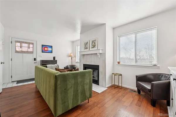 a living room with furniture and a wooden floor