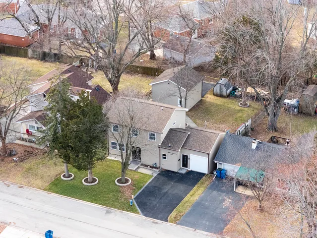 an aerial view of a house with yard