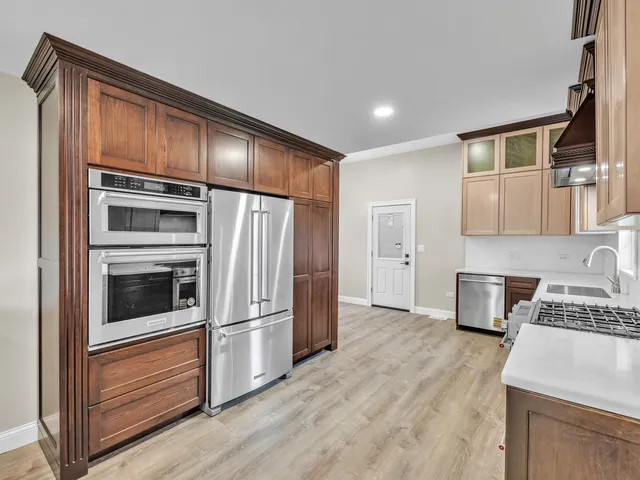 a kitchen with granite countertop stainless steel appliances and wooden cabinets