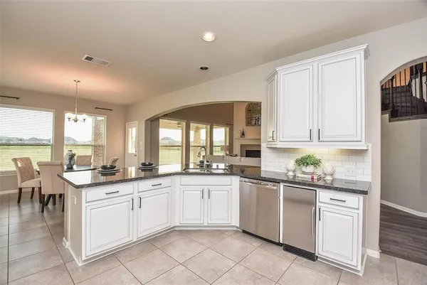 a kitchen with a sink window and cabinets