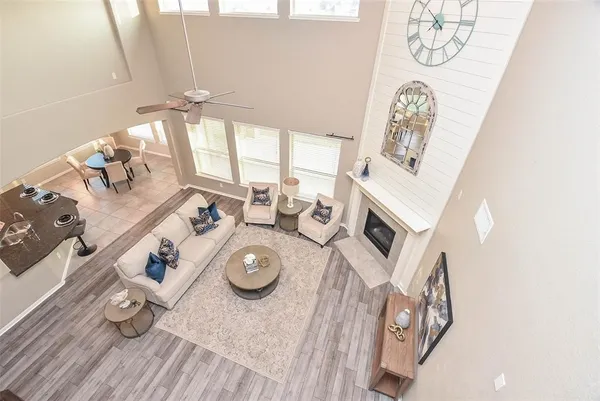 a view of a dining room with furniture a chandelier and wooden floor