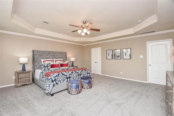 a bedroom with a bed and a chandelier