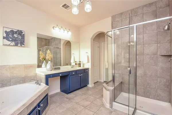a bathroom with a double vanity sink mirror and shower