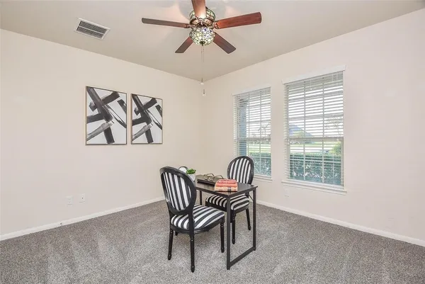 a dining room with furniture and window