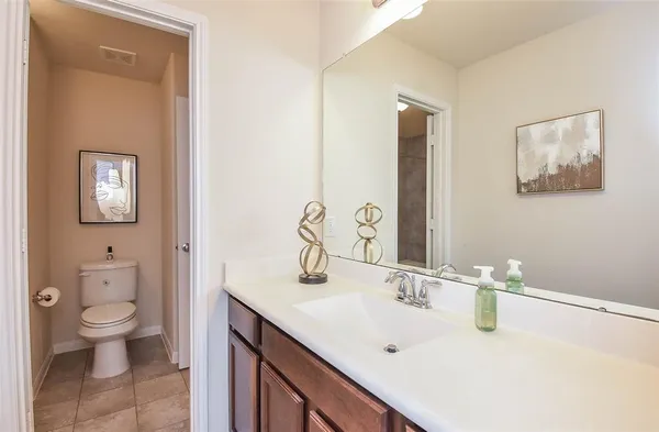 a bathroom with a sink vanity and a mirror