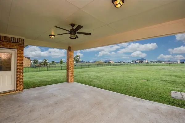 a front view of a house with a yard and mountain view