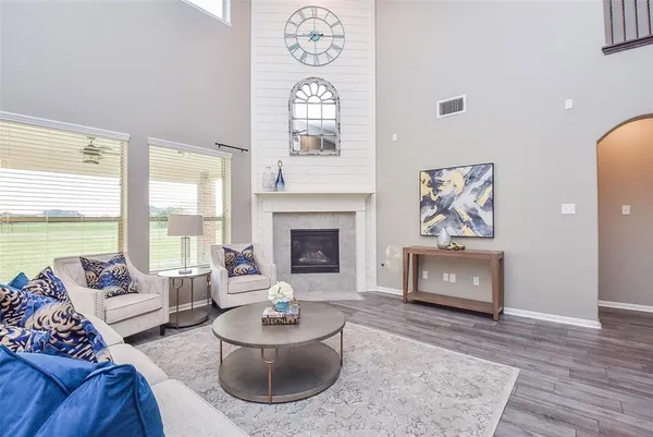 a living room with furniture a window and a fireplace