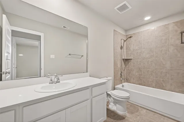 a bathroom with a sink toilet vanity and shower