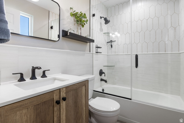 415 360 East Salem, UT 84653 - Photo 12 of 20 Bathroom featuring a wood-finish vanity with a white countertop and integrated sink, matte black faucet, and coordinating framed mirror