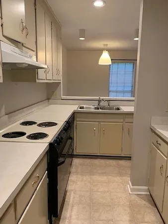 a kitchen with a sink appliances and cabinets