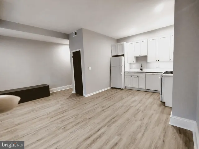 a view of a kitchen with wooden floor