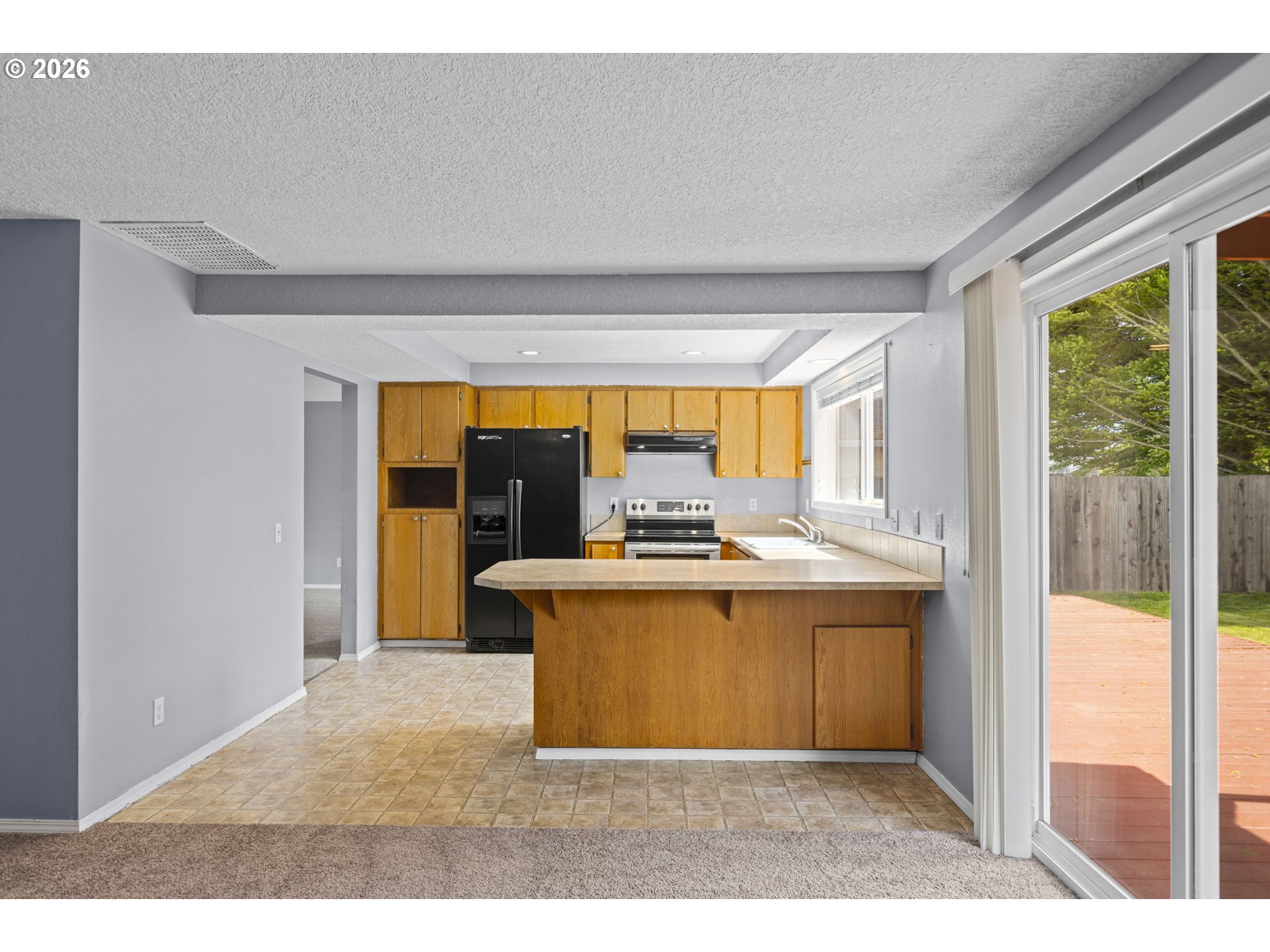 21558 Southwest Longacre Street Beaverton, OR 97003 - Photo 11 of 41 a view of living room with stainless steel appliances granite countertop furniture and a large window