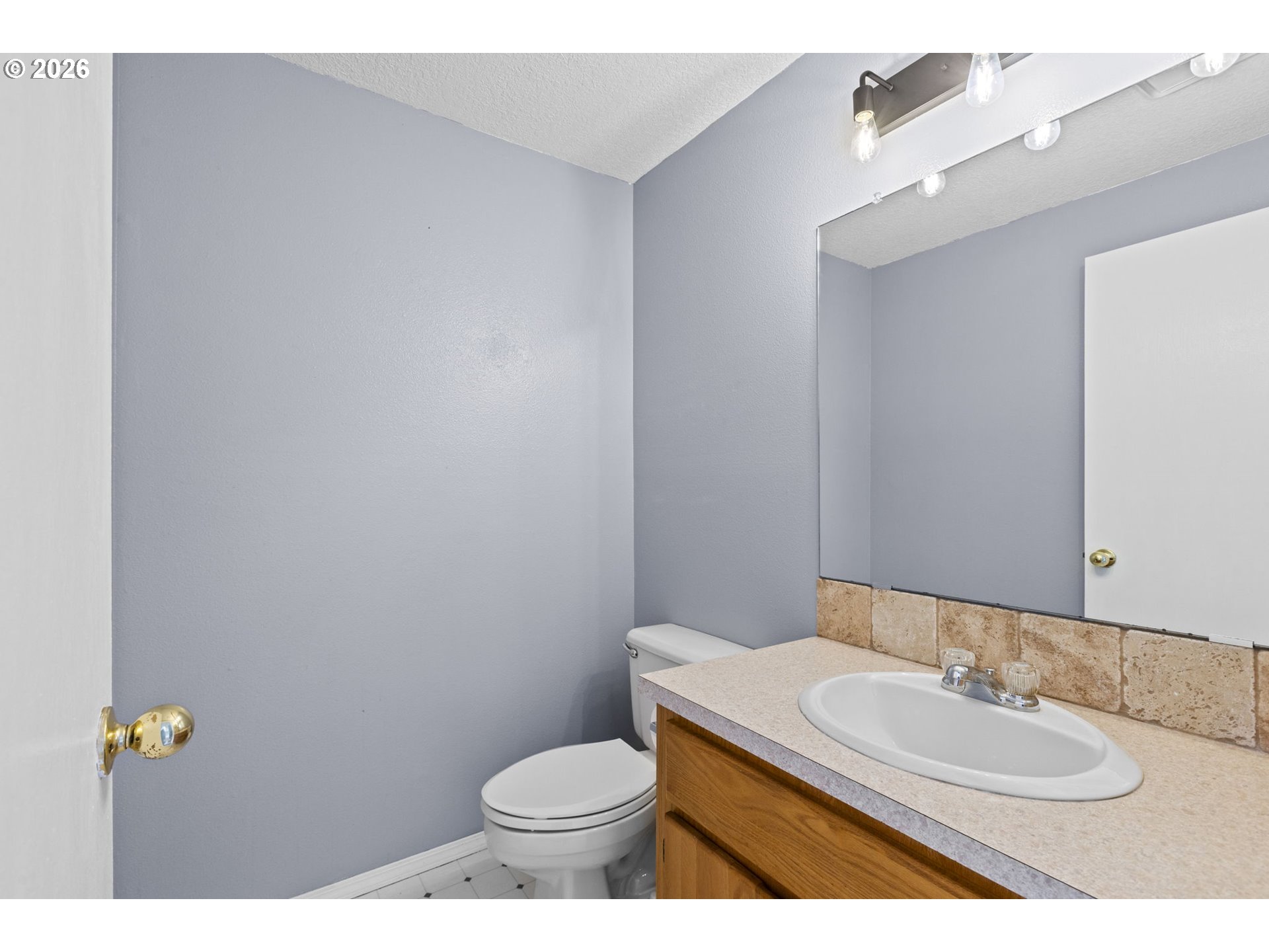 21558 Southwest Longacre Street Beaverton, OR 97003 - Photo 18 of 41 a bathroom with a granite countertop sink and a mirror with toilet