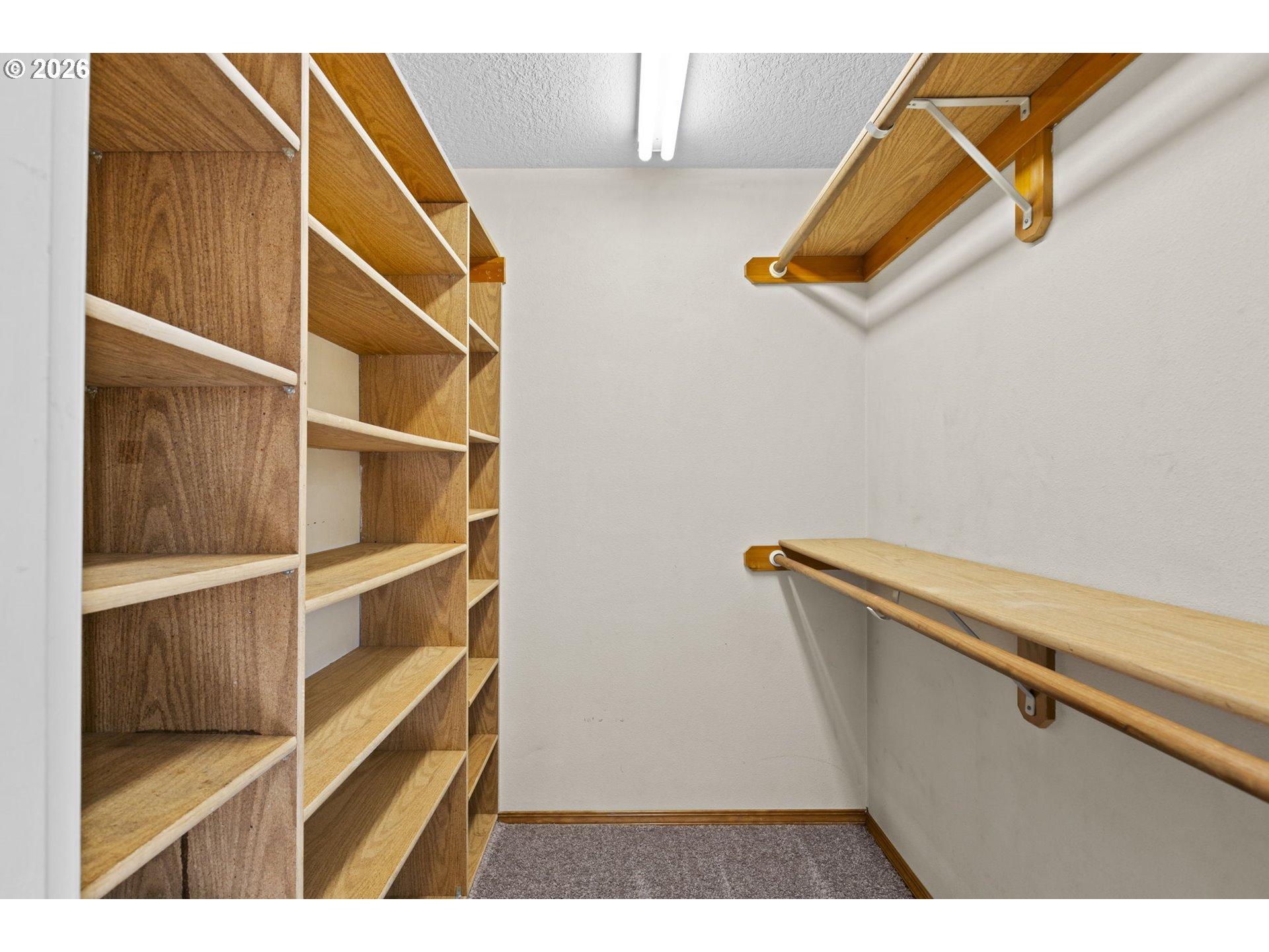 21558 Southwest Longacre Street Beaverton, OR 97003 - Photo 24 of 41 a view of walk in closet with empty racks