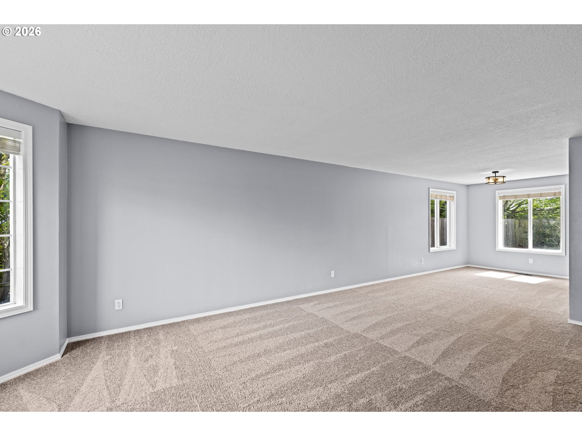 21558 Southwest Longacre Street Beaverton, OR 97003 - Photo 6 of 41 a view of an empty room with a window