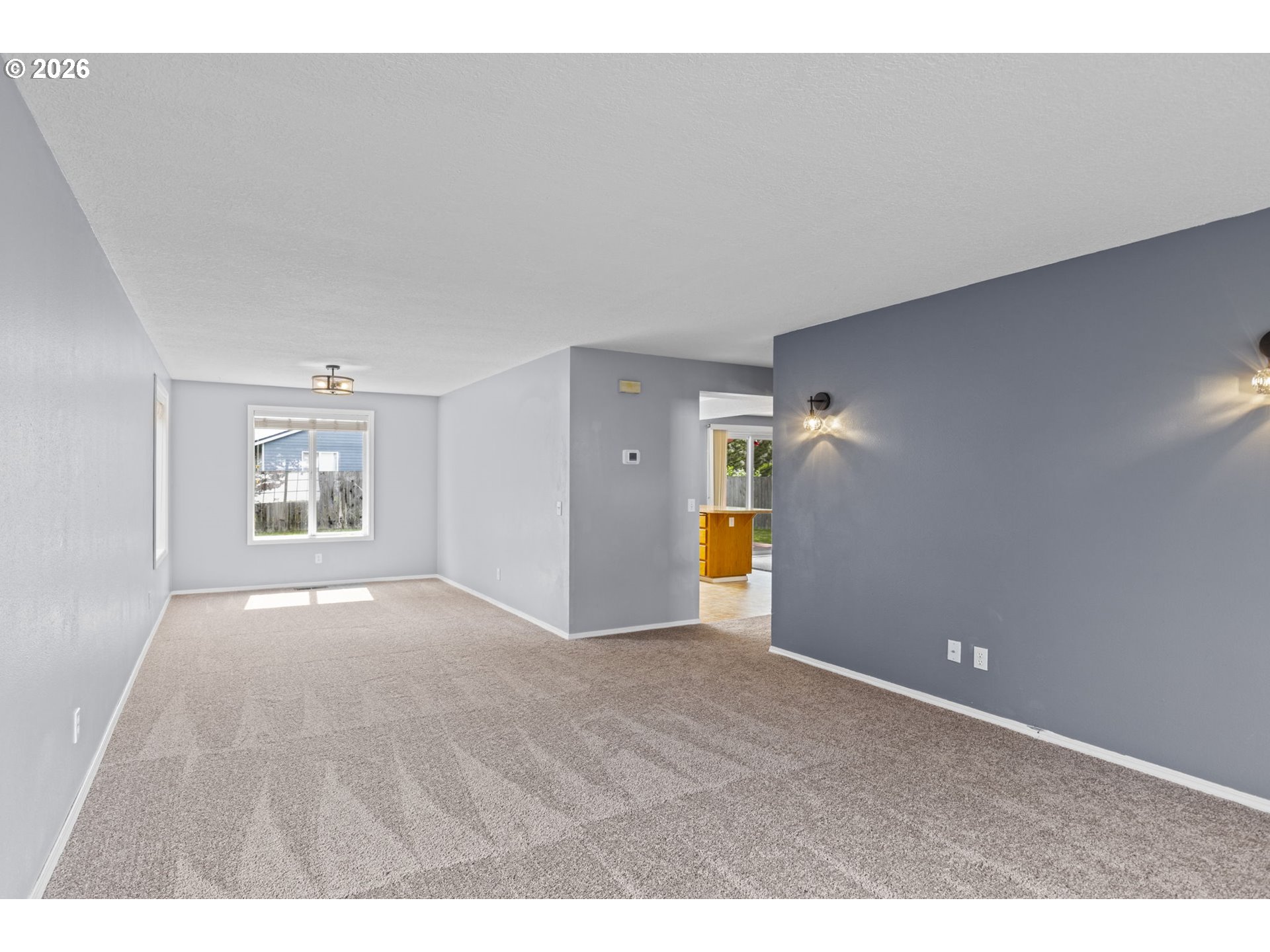 21558 Southwest Longacre Street Beaverton, OR 97003 - Photo 9 of 41 a view of an empty room and a kitchen
