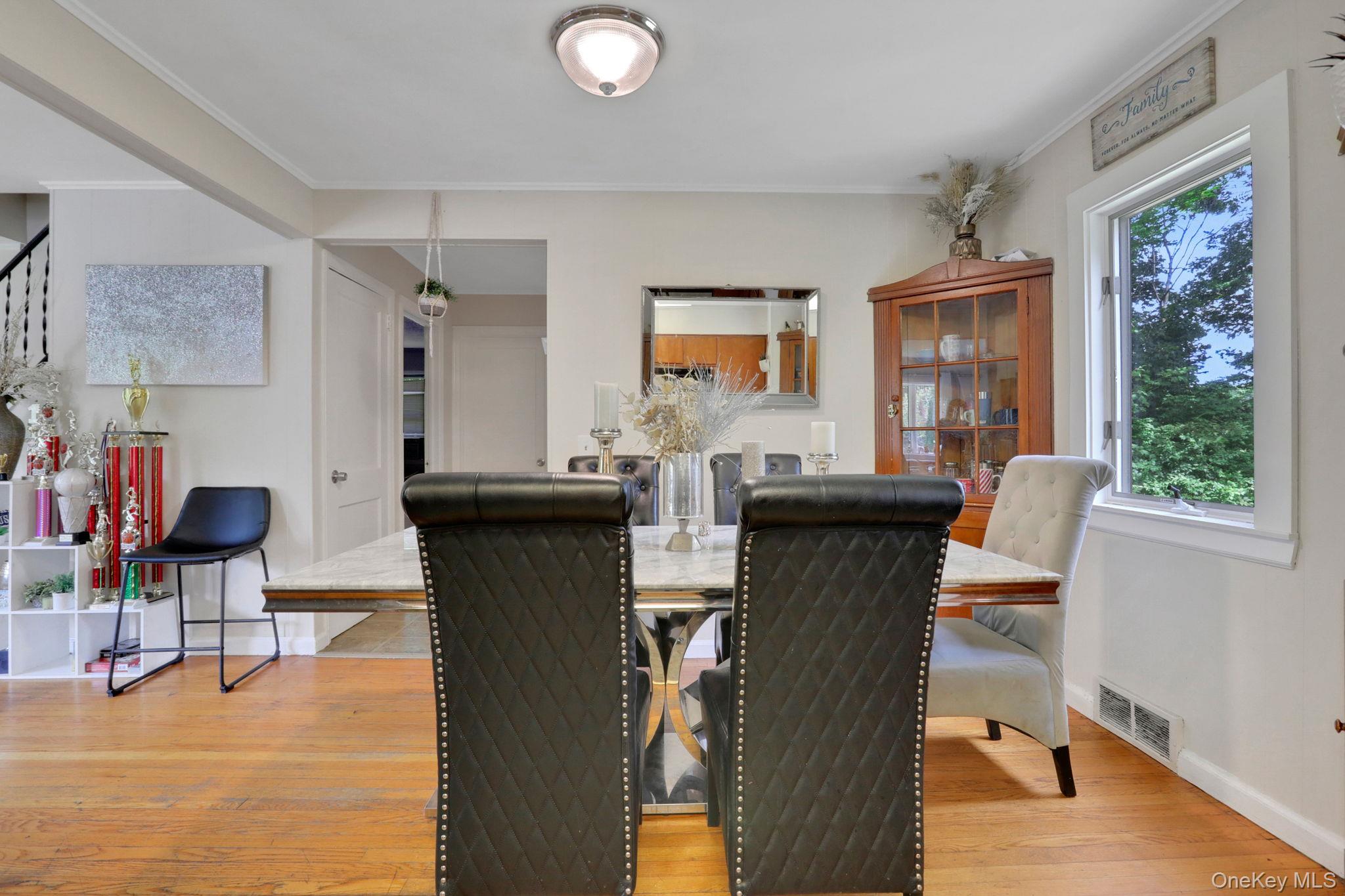 27 Osborne Hill Road Wappingers Falls, NY 12590 - Photo 12 of 31 Dining room with crown molding, light wood finished floors, and stairs