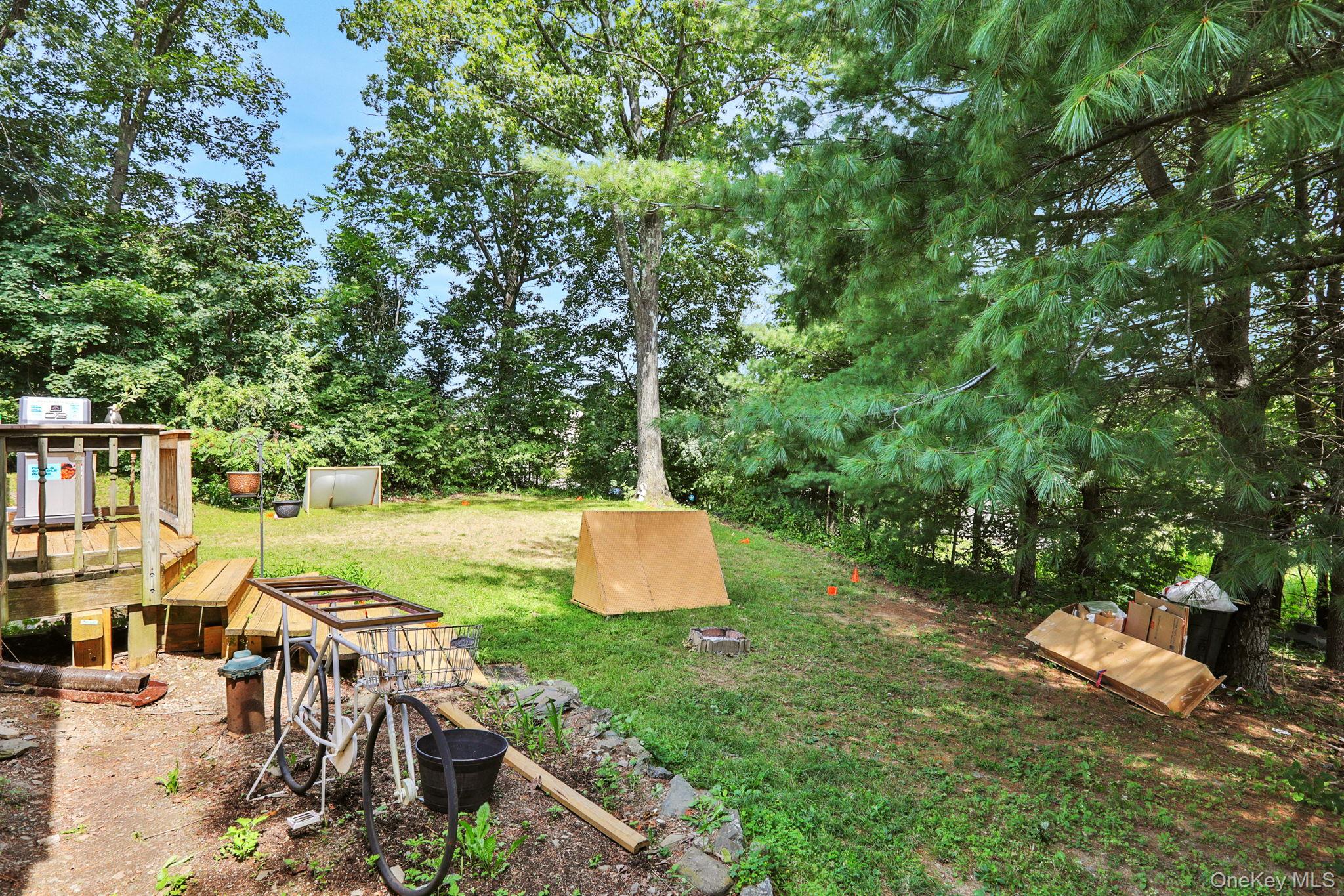 27 Osborne Hill Road Wappingers Falls, NY 12590 - Photo 22 of 31 View of grassy yard with view of scattered trees and a wooden deck