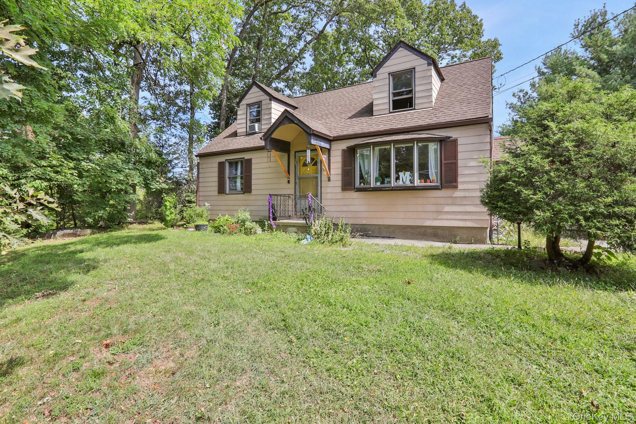 27 Osborne Hill Road Wappingers Falls, NY 12590 - Photo 3 of 31 New england style home with a front lawn, roof with shingles, and cooling unit