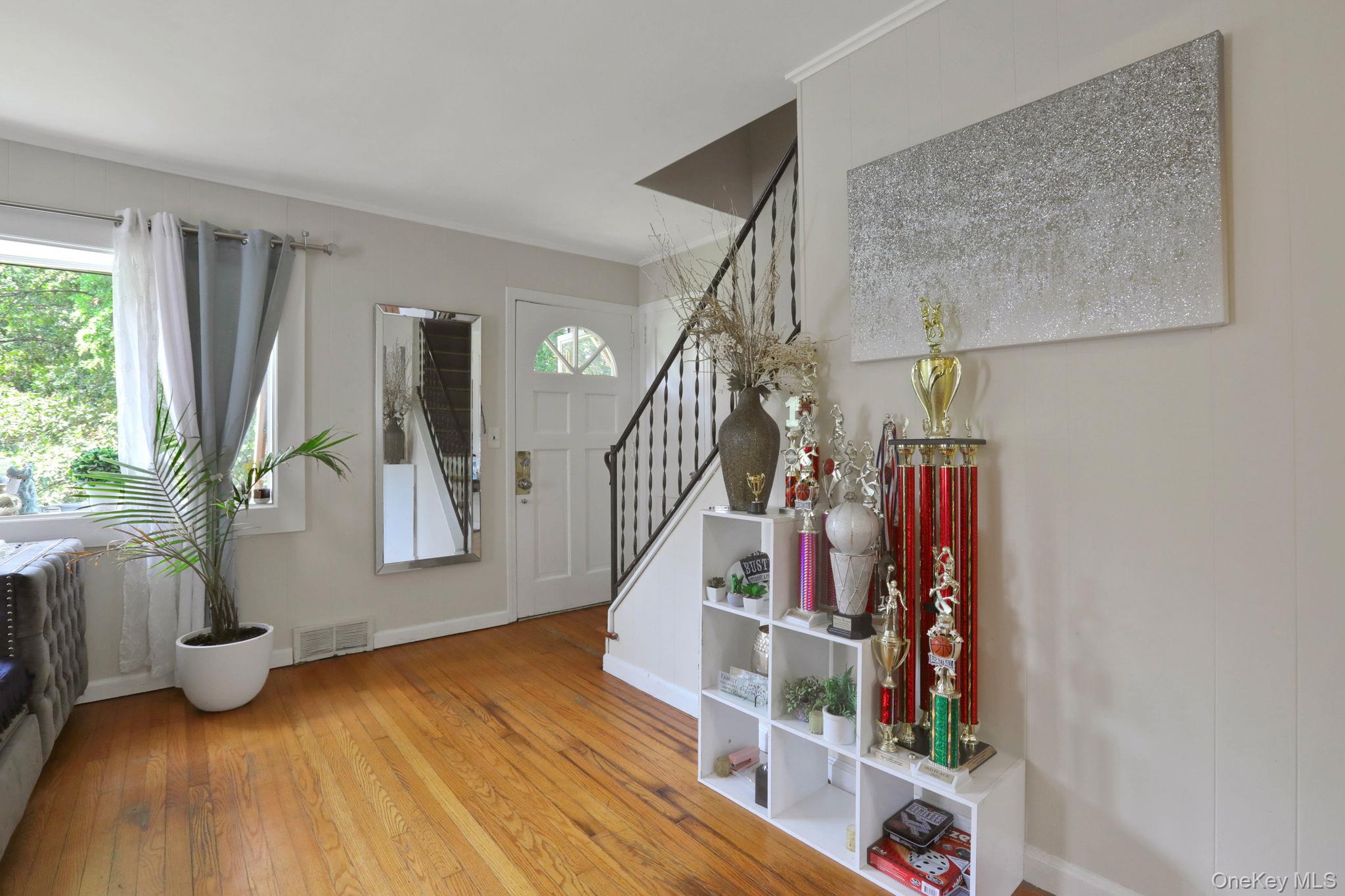 27 Osborne Hill Road Wappingers Falls, NY 12590 - Photo 8 of 31 Foyer featuring stairs, light wood-style flooring, and ornamental molding
