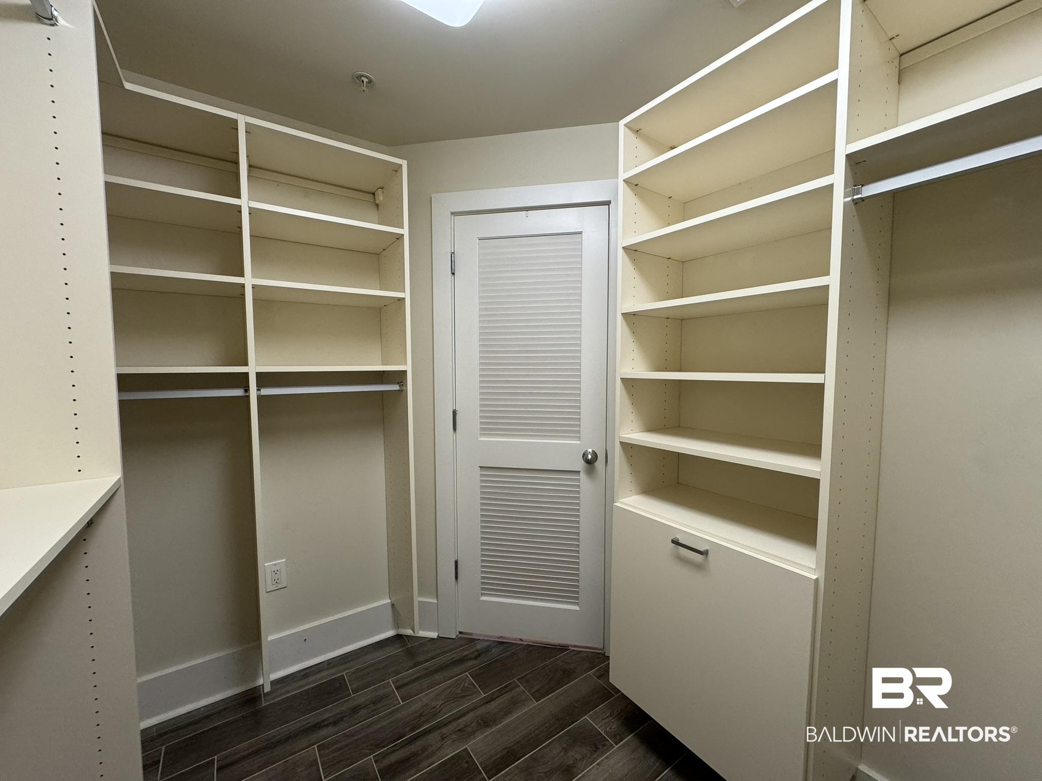 28107 Perdido Beach Boulevard, Unit D714 Orange Beach, AL 36561 - Photo 34 of 88 Walk in closet featuring wood finish floors