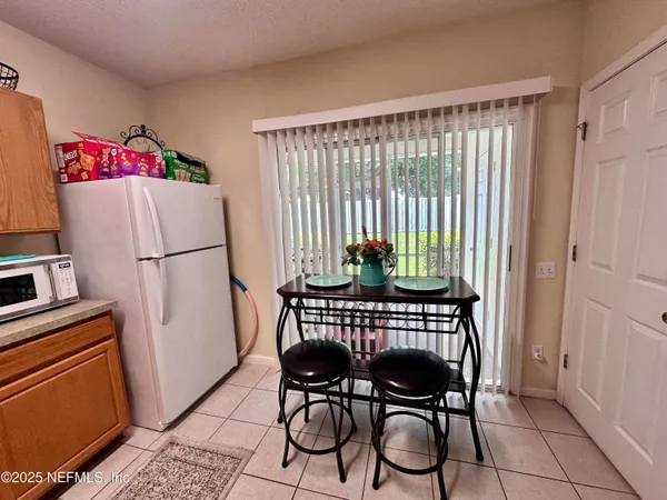 a view of a room with furniture and wooden floor