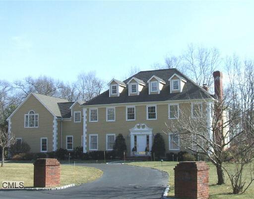 16 Chestnut Hill Road Wilton, CT 06897 - Photo 1 of 1 a front view of a house with a yard
