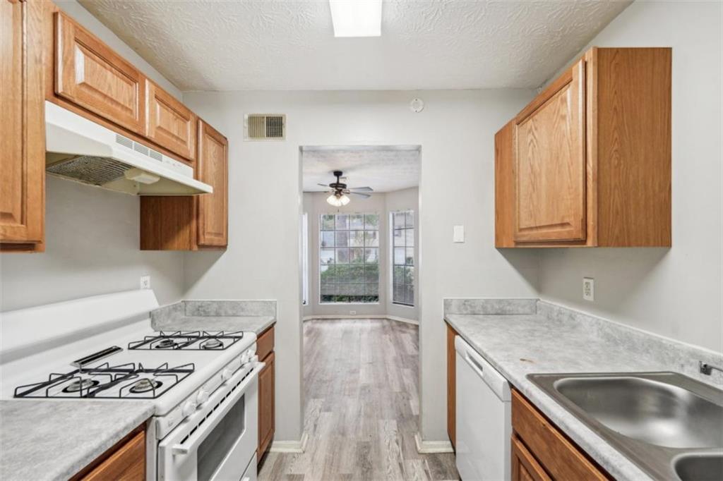 703 Pine Tree Trail Atlanta, GA 30349 - Photo 14 of 32 a kitchen with a stove and a sink