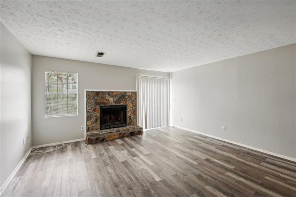 703 Pine Tree Trail Atlanta, GA 30349 - Photo 16 of 32 wooden floor in an empty room with a window